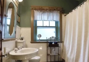 A private bathroom featuring an antique pedestal sink and a one-person whirlpool tub for a relaxing soak