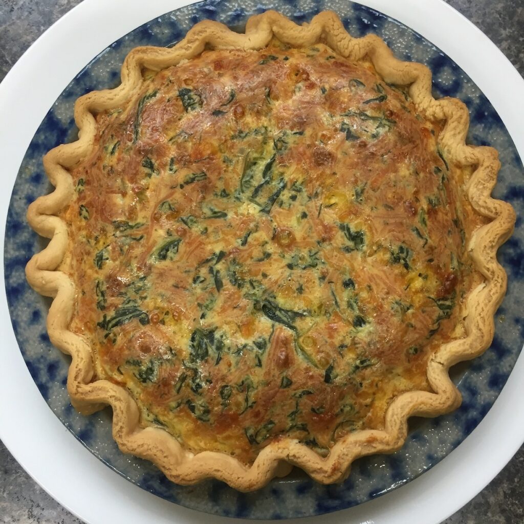 lightly browned spinache quiche in a pastry crust - overhead view