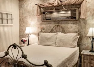 A comfortable queen-sized bed with plush bedding in the Carriage House at Olde Square Inn.