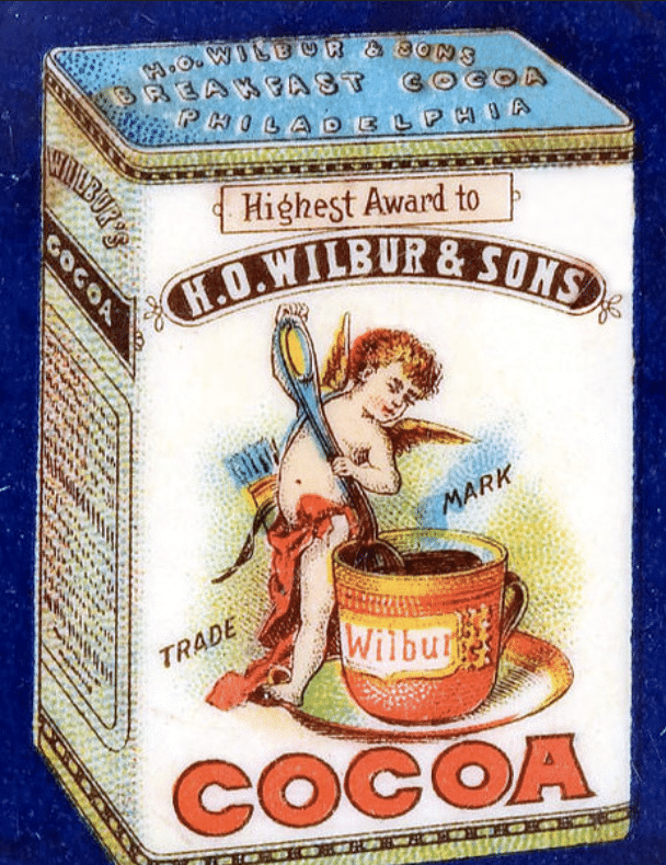 Vintage can of Wilbur cocoa, white tin with angel stirring a pot of chocolate
